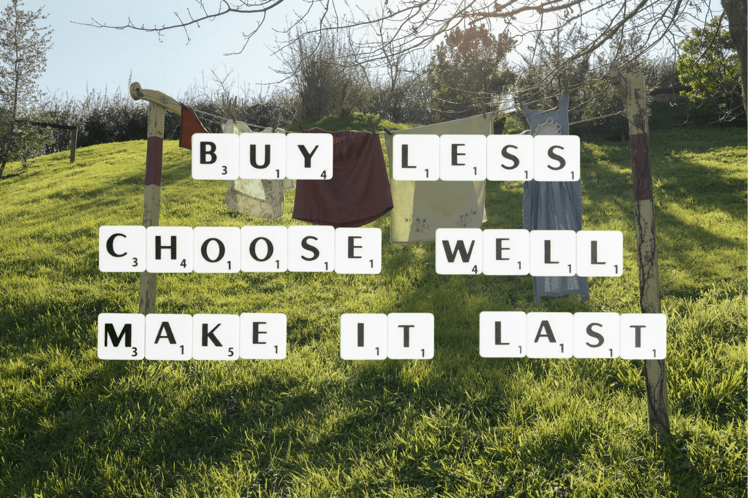 Clothes hanging on an outdoor washing line in a green landscape with text reading “Buy less, choose well, make it last.”