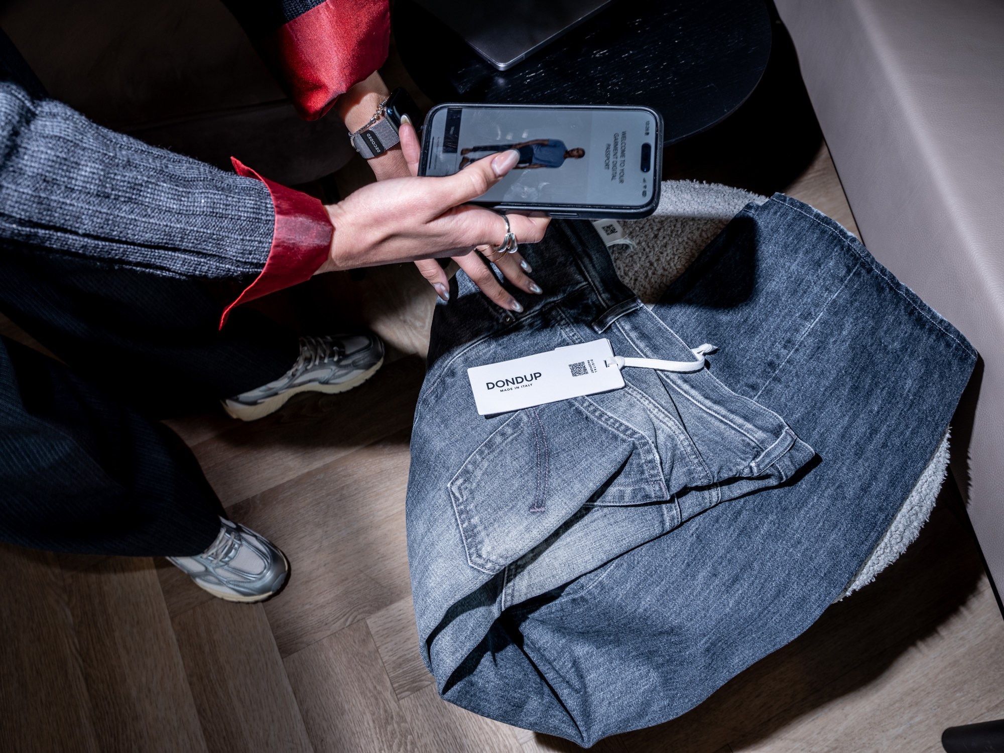 woman scanning a jeans label with a phone